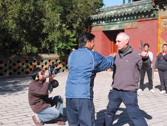 Peter being filmed getting a tai chi lesson