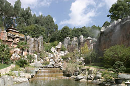 Ornamental garden with waterfall and cliffs