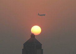 Plane and setting sun over Guangzhou