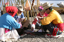 Mosuo men and women playing cards by the shore of Lugu Lake