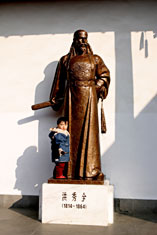 Little boy with statue of Taiping leader Hong Xiuquan, Nanjing