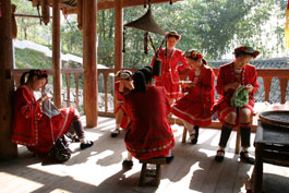 Girls in minority group costume knitting, Silver Cave, near Yangshuo